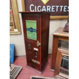 Early 20th C. mahogany Richmond Gem cigarette dispensing machine.