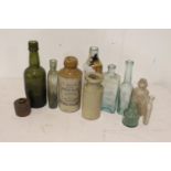 Collection of nine glass bottles and two stoneware bottles.