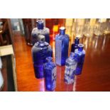 Seven Bristol blue glass chemist bottles.