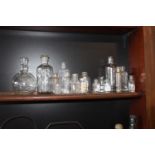 Sixteen clear glass chemist bottles