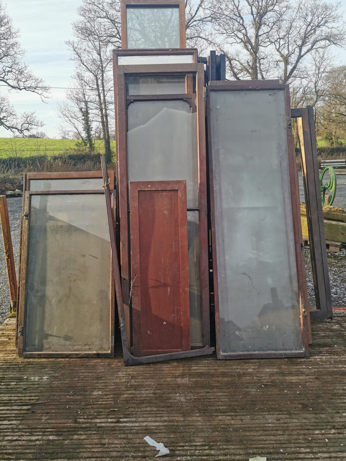 Large collection of mahogany chemist shop cabinet doors.