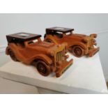 Two carved wooden 1932 Model 19 Ford cars. {