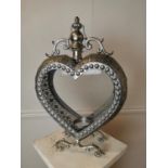 Decorative metal candle holder in the shape of a heart