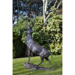 Cast iron model of Stag standing on craggy rock