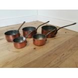 Good quality set of five graduated copper and metal saucepans.