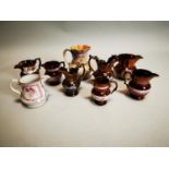 Collection of eight ceramic water jugs.