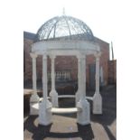 Composition stone gazebo with metal roof.