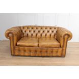 Leather upholstered deep buttoned two seater Chesterfield sofa.