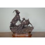 Bronze figural group of Mountain Goats on rocky ground signed .