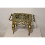 Ornate brass trivet.