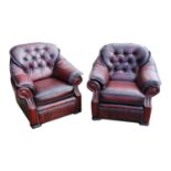 air of leather upholstered deep buttoned armchairs.