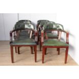 Six green leather upholstered armchairs