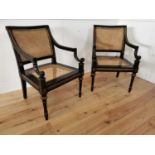 Pair of ebonised and gilded open armchairs