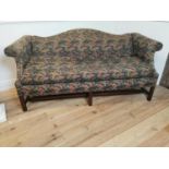 Mahogany and upholstered camel backed sofa