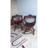 Pair of decorative oak throne chairs with carved back and leather seats.