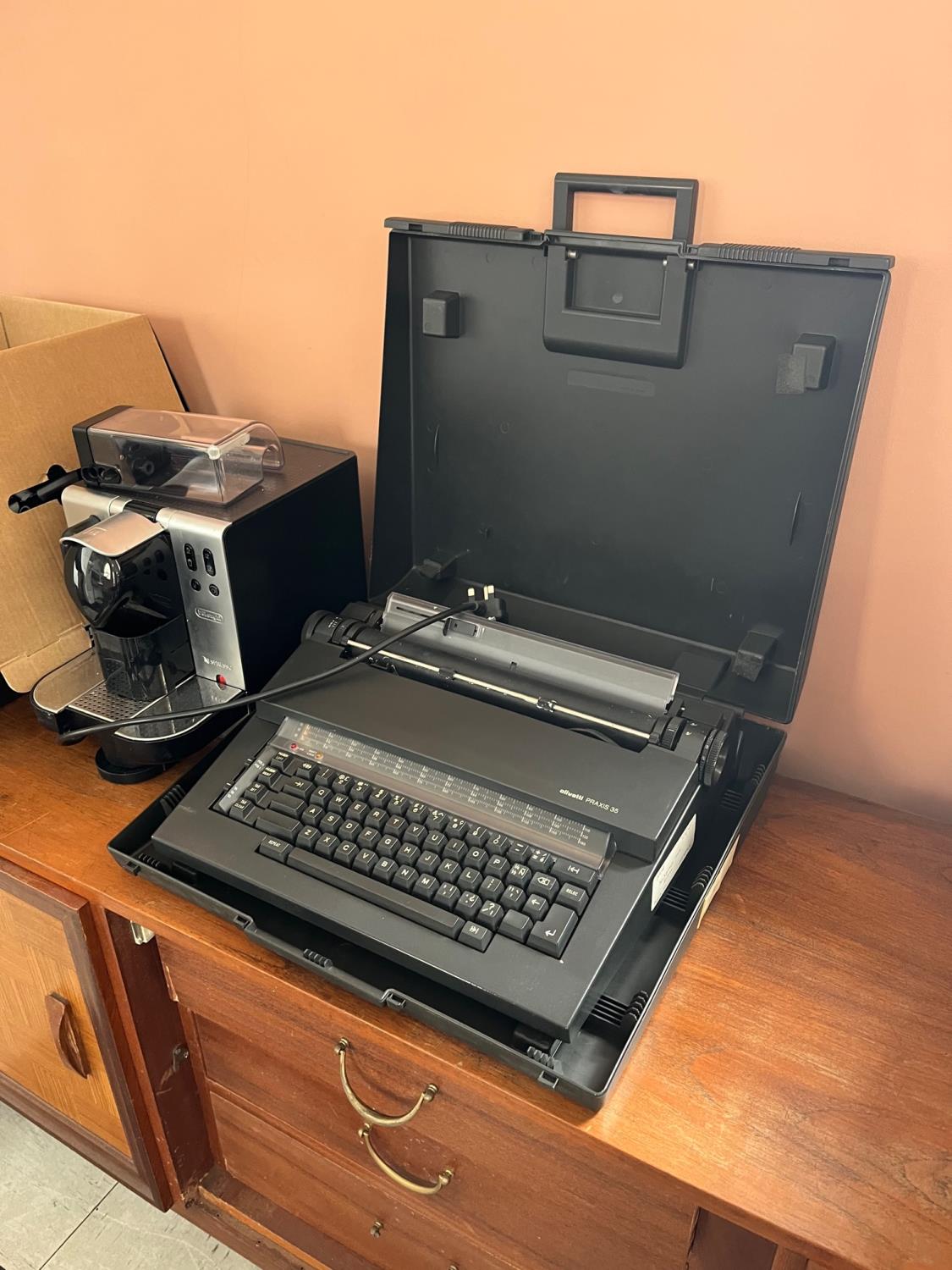 DeLonghi coffee machine and a vintage electric Olivetti typewriter