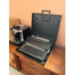 DeLonghi coffee machine and a vintage electric Olivetti typewriter