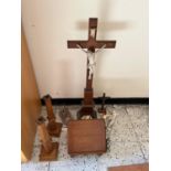 Pair of oak candlesticks, a book holder, and a collection of crucifixes