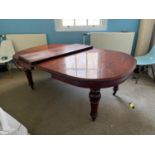 Victorian mahogany dining table with two extra leaves on turned legs and ceramic casters {250 cm W x