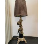 Pair of brass lamps in the form of boys with cloth shades. { 49cm H }.