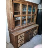 Mexican pine two piece kitchen dresser with two glazed sliding doors above two centre doors