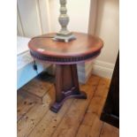 Modern mahogany centre table raised on tapered shaped column and three sleigh feet {66cm H X 61cm