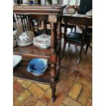 19th. C. three tier pine whatnot with turned columns and raised on ceramic casters { 104cm H X 130cm