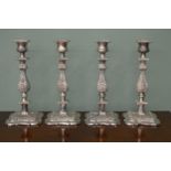 Four embossed silver plate candle sticks. {30 cm H x 15 cm Dia}