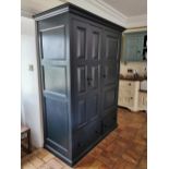 Painted ash and oak kitchen cupboard, the two long panelled doors enclosing shelving and a long