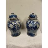 Pair of Oriental blue and white ceramic lidded vases { 45cm H }.