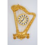 Brass wall clock in the shape of a Harp. {50 cm H x 35 cm Dia}.