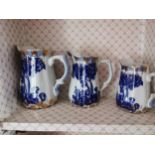 Set of five graduated blue and white ceramic jugs { 21cm H X 14cm Dia - 11cm H X 9cm Dia }.