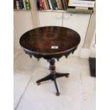 19th. C. ebonised and gilt centre table the circular top raised on turned column and three out swept