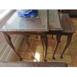 20th. C. nest of three mahogany tables with inset glass tops. { 56cm H X 51cm W X 39cm D }.