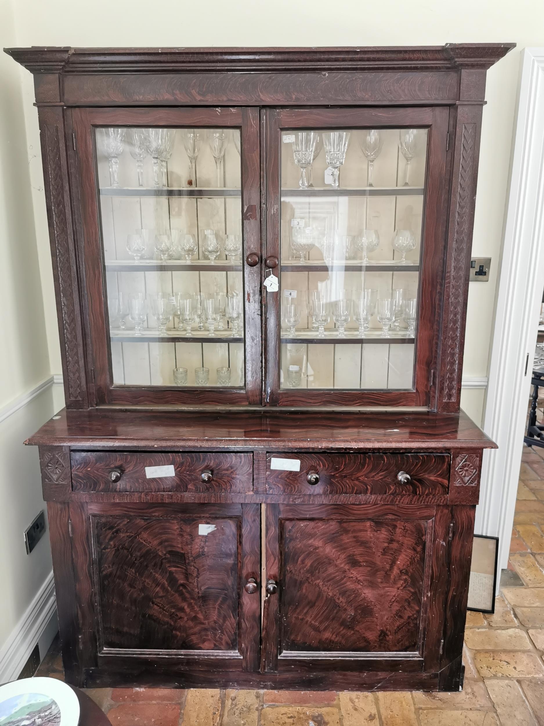 19th. C. scumbled pine glass case, the two glazed doors over two drawers and two panelled doors. {