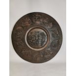 Large embossed brass Oriental wall plaque depicting various battle scenes. {96 cm Dia}.
