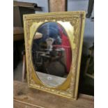 Decorative gilt mirror with oval plate { 93cm H X 66cm W }.