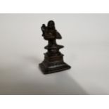 Bronze figure of Oriental deity. {7 cm H x 4 cm W x 4 cm D}