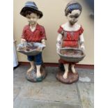 Pair of cast iron figures of Boy and Girl holding baskets {98 cm H}.
