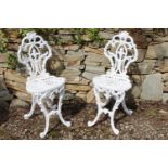 Pair of decorative cast iron garden chairs. {87 cm H x 35 cm W x 38 cm D}.