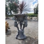 Good quality moulded stone urn held aloft by three cherubs decorated with swags in the French