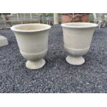 Pair of moulded stone urns {52 cm H x 43 cm Dia.}.