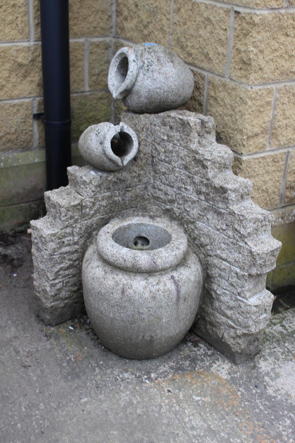 Granite jug water feature. {193 cm H x 63 cm W x 54 cm D}.