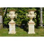 Pair of cast iron urns with mask decoration and serpent handles on matching bases. {200 cm H x 62 cm