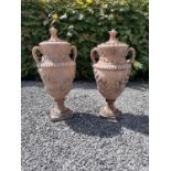 Pair of moulded stone terracotta Swedish lidded urns with leaf decoration. {90 cm H x 40 cm Dia}.