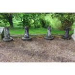 Four stone bollards with chains. {72 cm H x 54 cm Dia}.