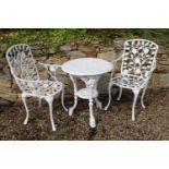 Decorative Cast iron garden table with two aluminium armchairs . Table {68 cm H x 62 cm Dia} and