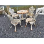 Cast iron decorative garden table with four matching chairs. Table {61 cm H x 57 cm Dia} and
