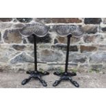 Pair of cast iron tractor seat bar stools. {78 cm H x 41 cm W x 33 cm D}