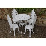 Cast aluminium garden table with four fern leaf decorated chairs. Table {68 cm H x 68 cm Dia} and